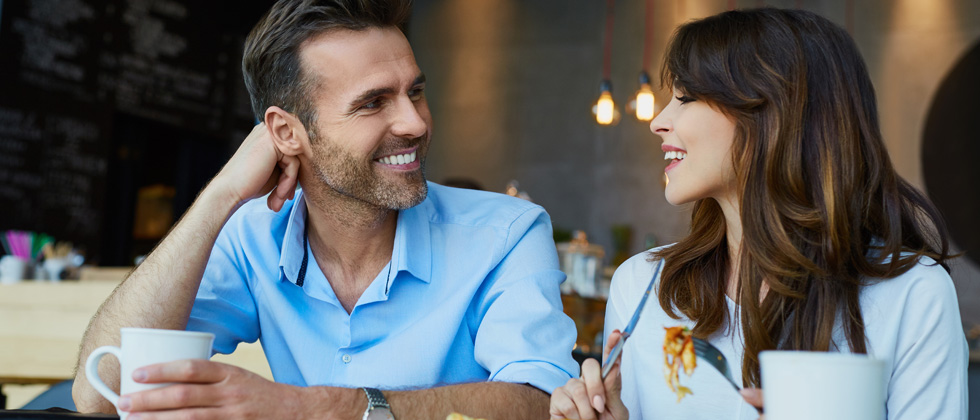 An attractive couple flirting over breakfast at a restaurant