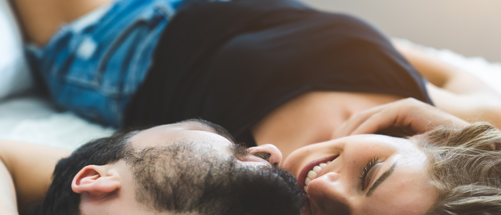 Couple having an intimate moment laying together