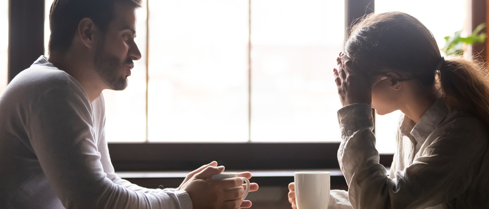 A couple having an intense discussion over coffee in the morning