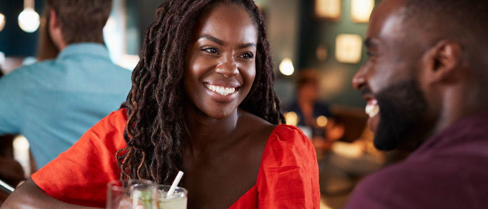 A man and woman flirting with each other at a bar