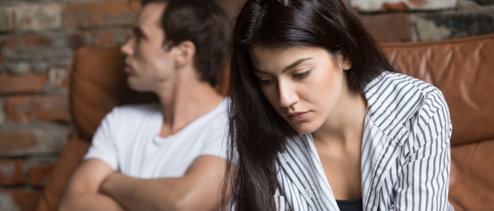 Couple working through an argument - man angry, woman upset