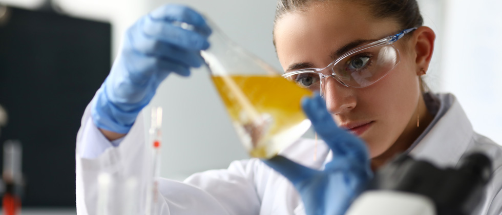 Female scientist mixing chemicals in a lab