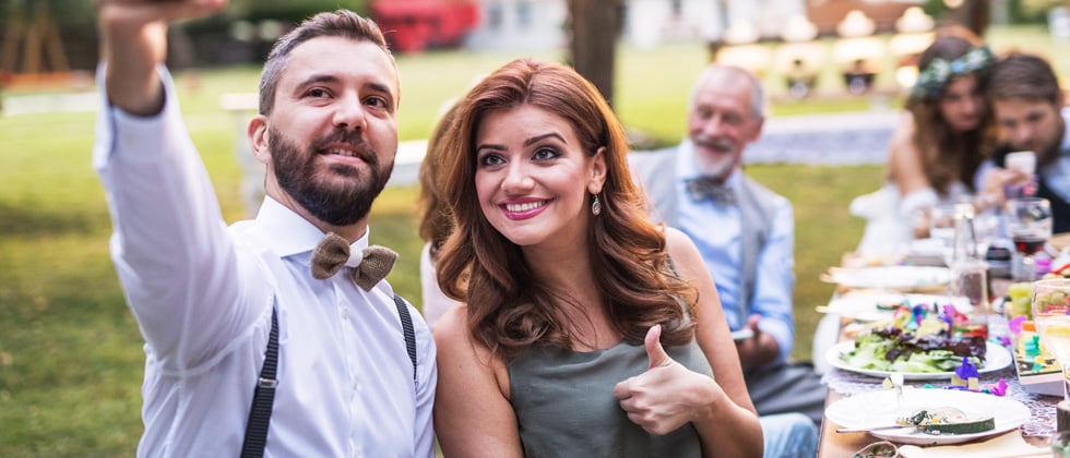 Couple dating a selfie at a wedding dinner