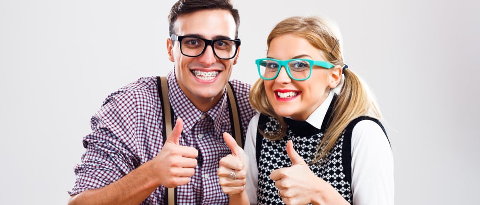 Couple dressed up as nerds in glasses and plaid sweaters