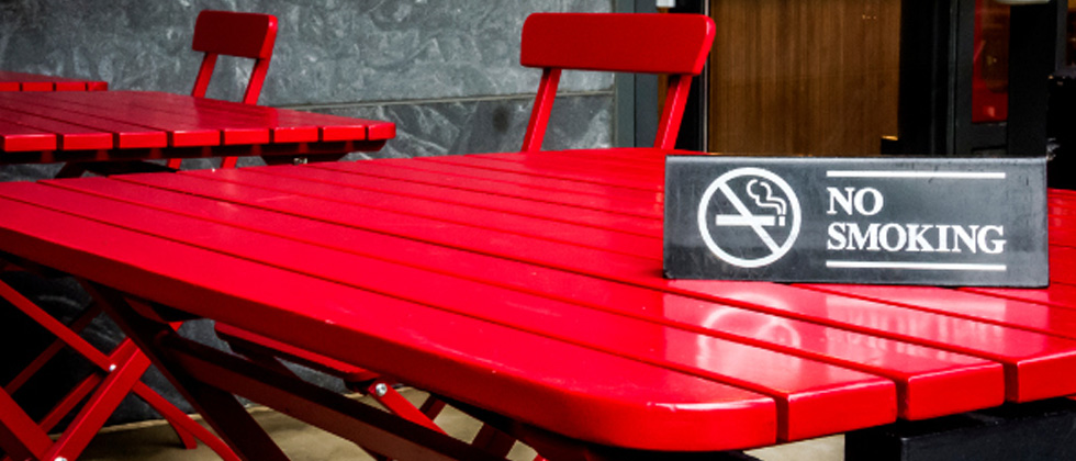 A red table with a NO SMOKING sign on it