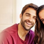 Christian couple smiling into camera