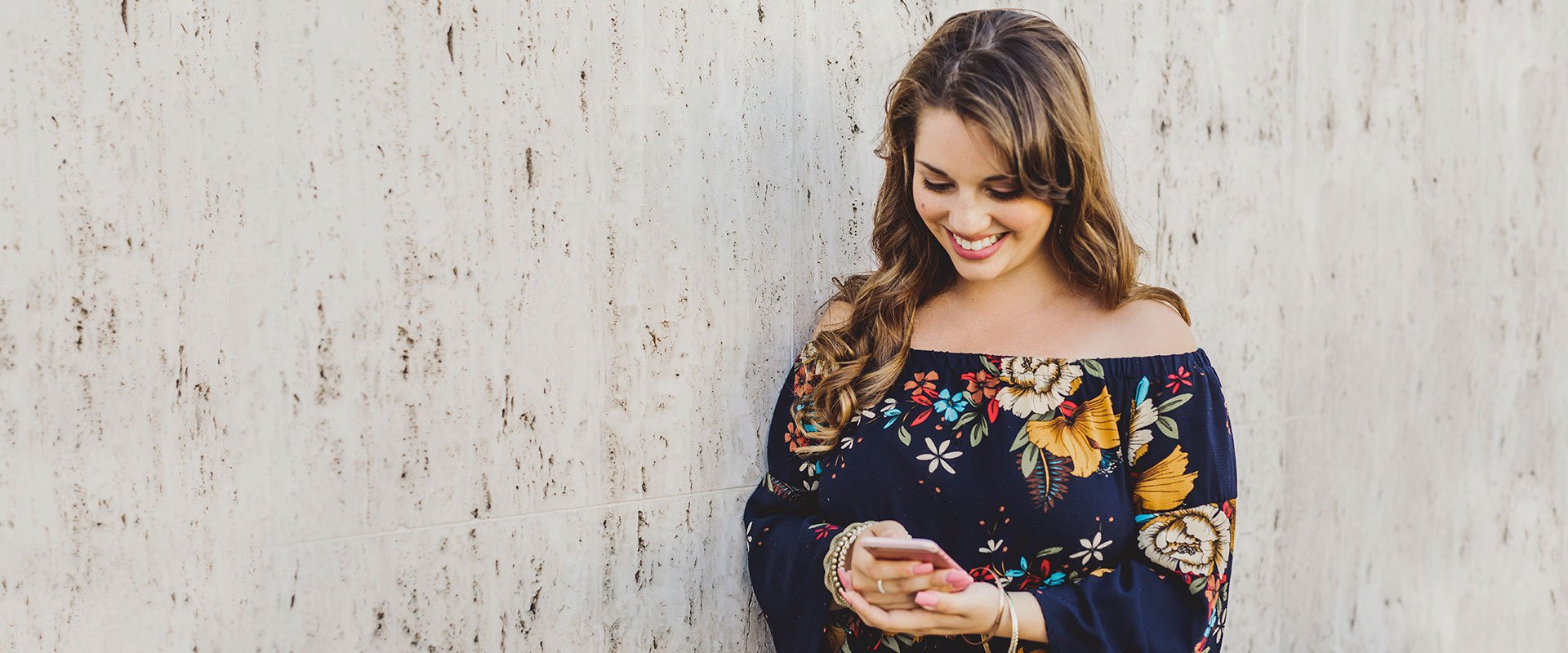 Free Dating symbolized by a single woman using eharmony and smiling in her smartphone