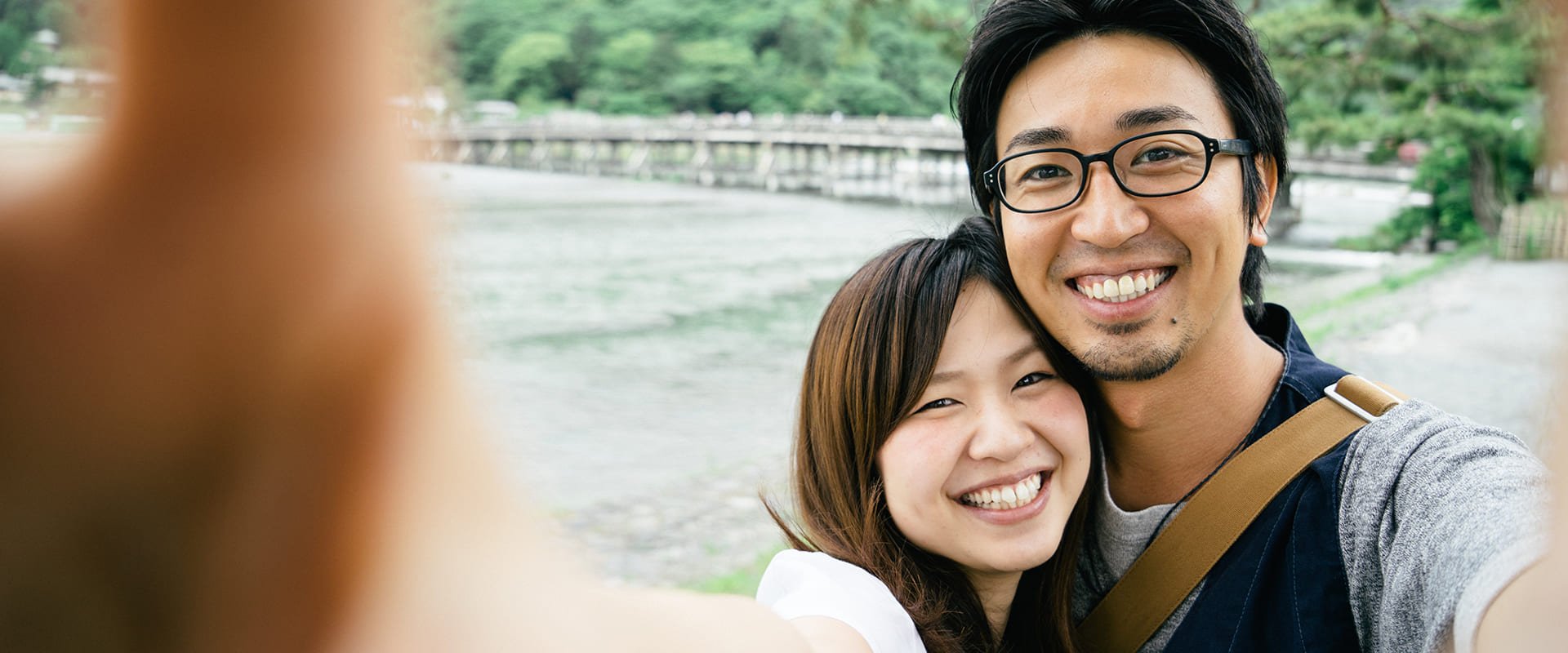 Japanese dating symbolized by a man and woman smiling into the camera