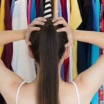 Woman standing in front of her closet not knowing what to wear