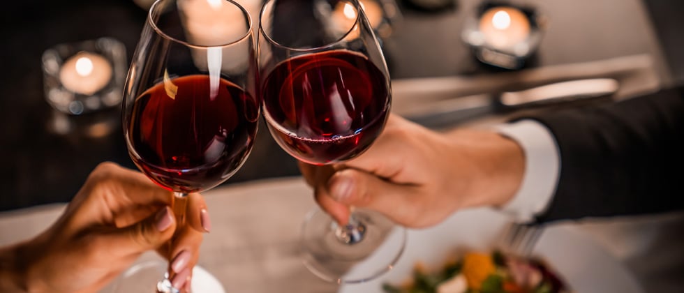 Couple on a dating cheering's with red wine