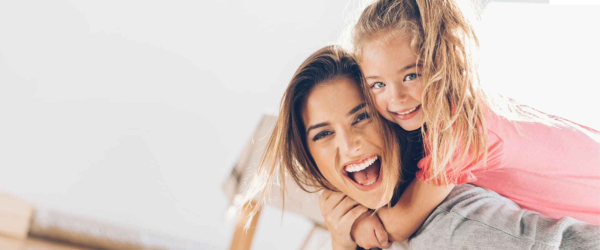 Single parent dating symbolized by mother carrying her child on her back and laughing into camera