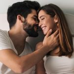 Man kissing woman with face in hand as symobl for how to kiss