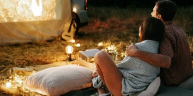 Man and woman have an outdoor date and watch a movie as an example of date ideas