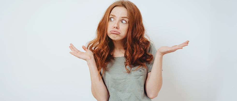 Girl looks amazed and raises hands in the air as a symbol of questions that you can ask a girl