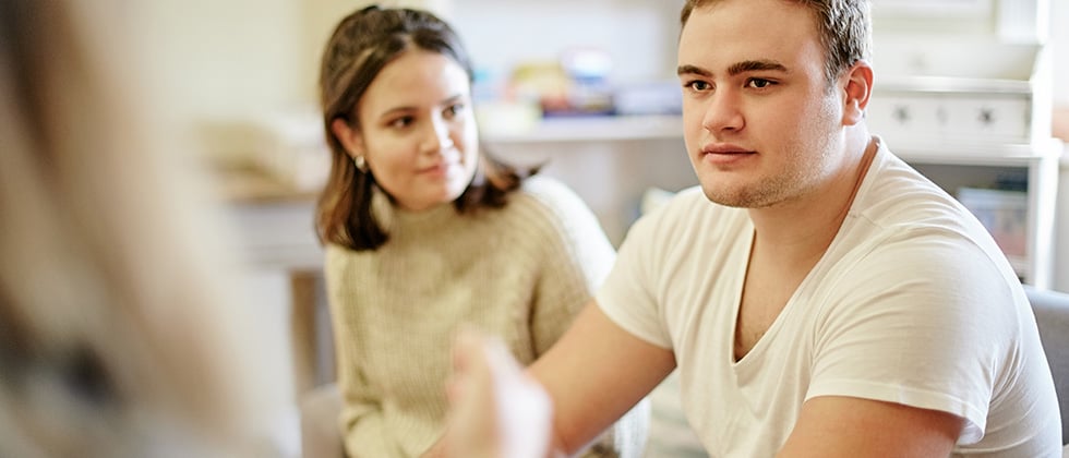 Man and woman sitting on the sofa as an example of questions to ask