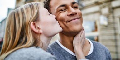 Woman kisses man on the cheek as a symbol of how to kiss well