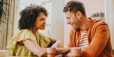 Man and woman drinking tea together and talking as a symbol of core values in a relationship