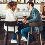 Man and woman sitting together in a bar and talking as symbol for dating rules