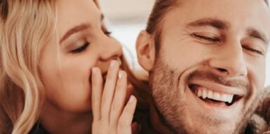 Woman whispers in man's ear as example of how to deal with mixed signals