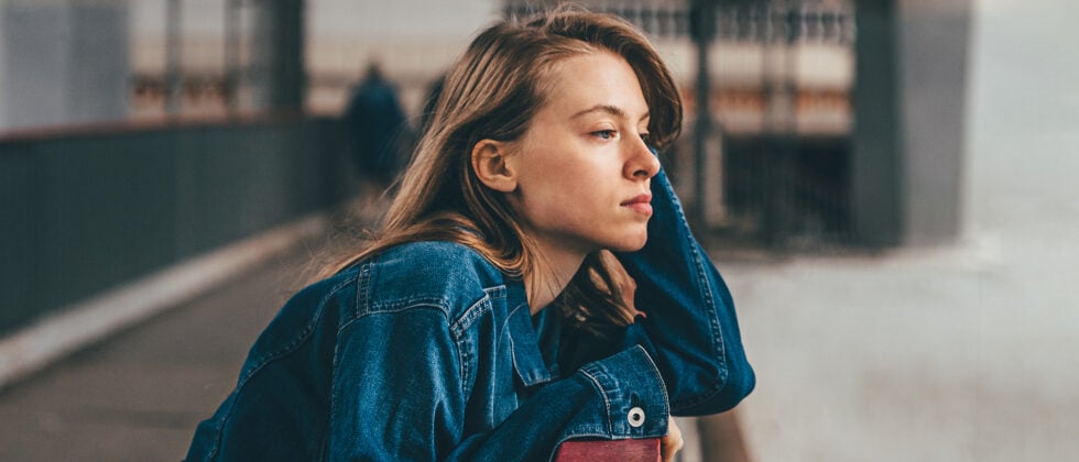 Woman looking thoughtfully into distance as symbol for flaky person