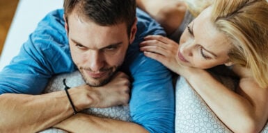 Man and woman on sofa and he looks thoughtful as symbol of love but not in love