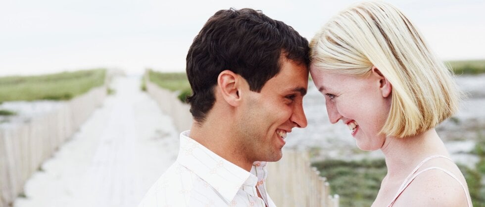 Older man and younger woman have faces leaning against each other as example of loyalty in relationship