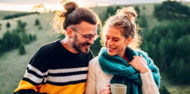 Man and woman laughing together outside in nature symbolizing different types of relationship
