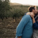 A man and a woman embrace and kiss as a symbol of international dating