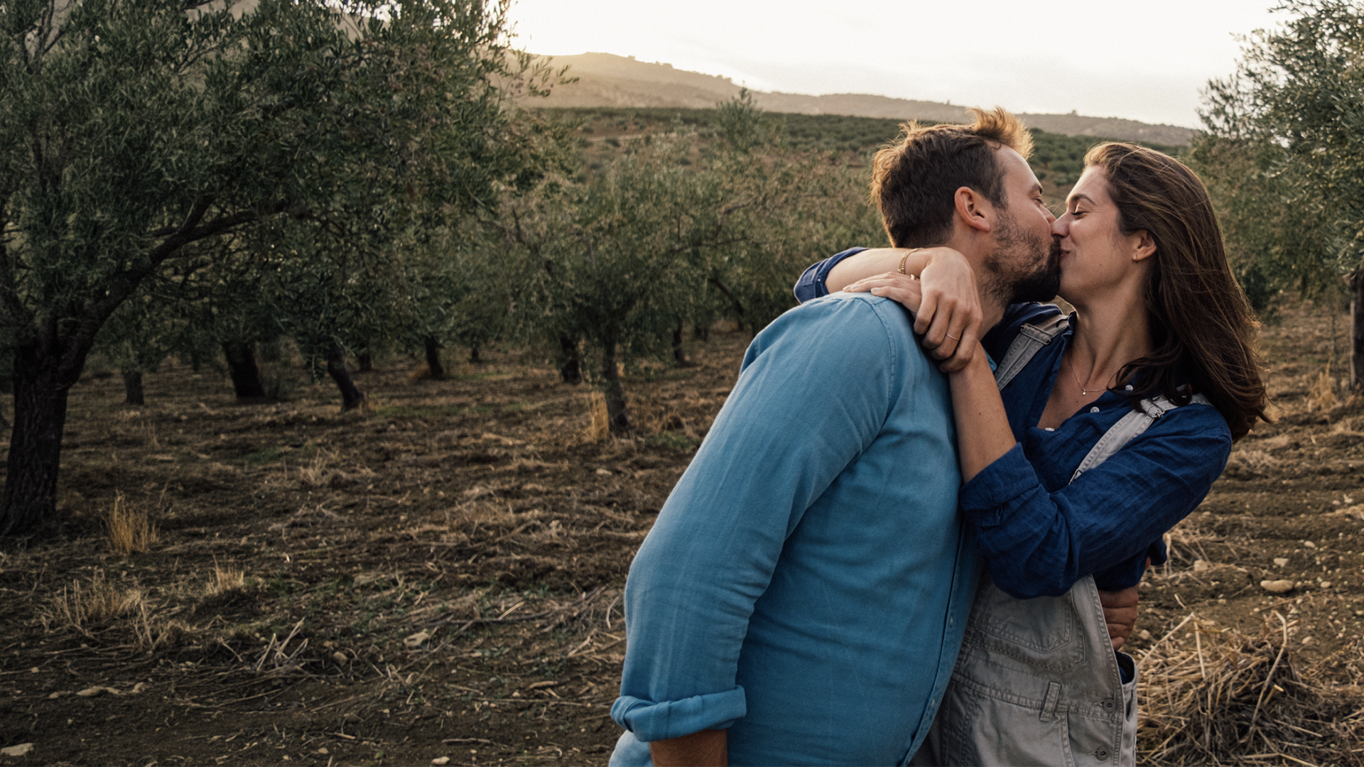 A man and a woman embrace and kiss as a symbol of international dating
