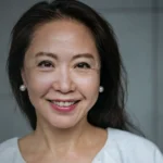 Mid-Life Chinese Single Woman smiling directly into the camera.