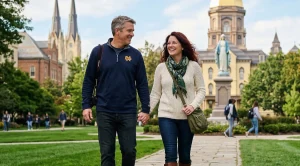 A couple walking hand in hand around the university of notre dame.