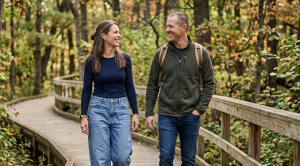 A couple walking side by side through fontenelle forest in bellevue, nebraska. (Generated with AI)
