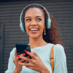 A woman writing funny questions to ask a guy on her phone