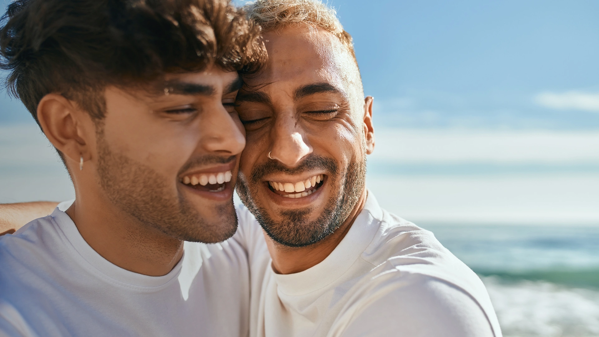A gay couple enjoying their time at the beach.