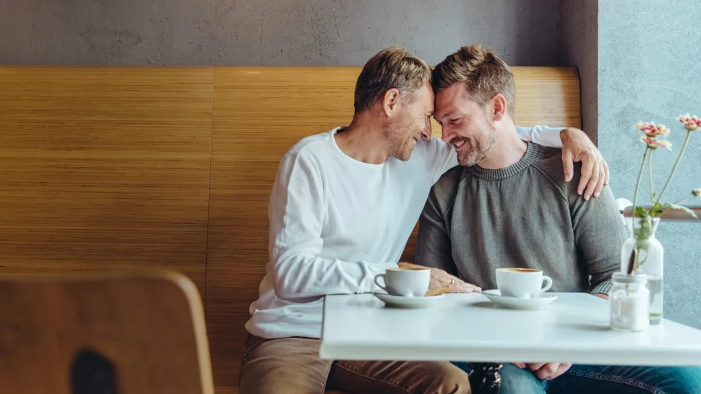 A gay couple on a date in a café in New York City.