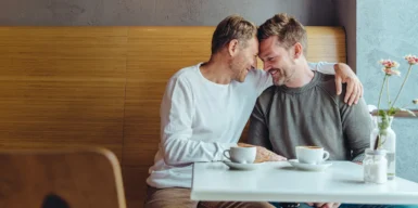 A gay couple on a date in a café in New York City.