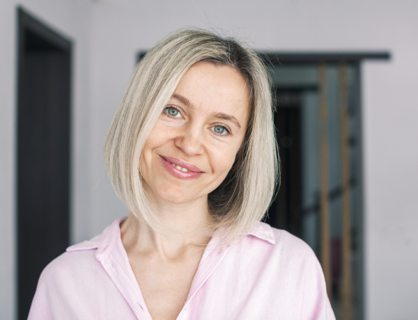 A woman smiles at the camera as example for matching
