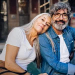 A woman and a man over 50 sitting next to each other.
